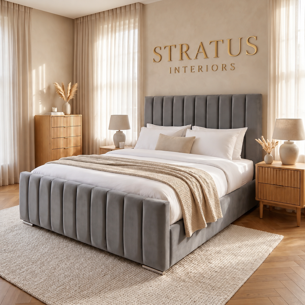 Athens grey upholstered bed with vertical panels and gold Stratus Interiors wall lettering